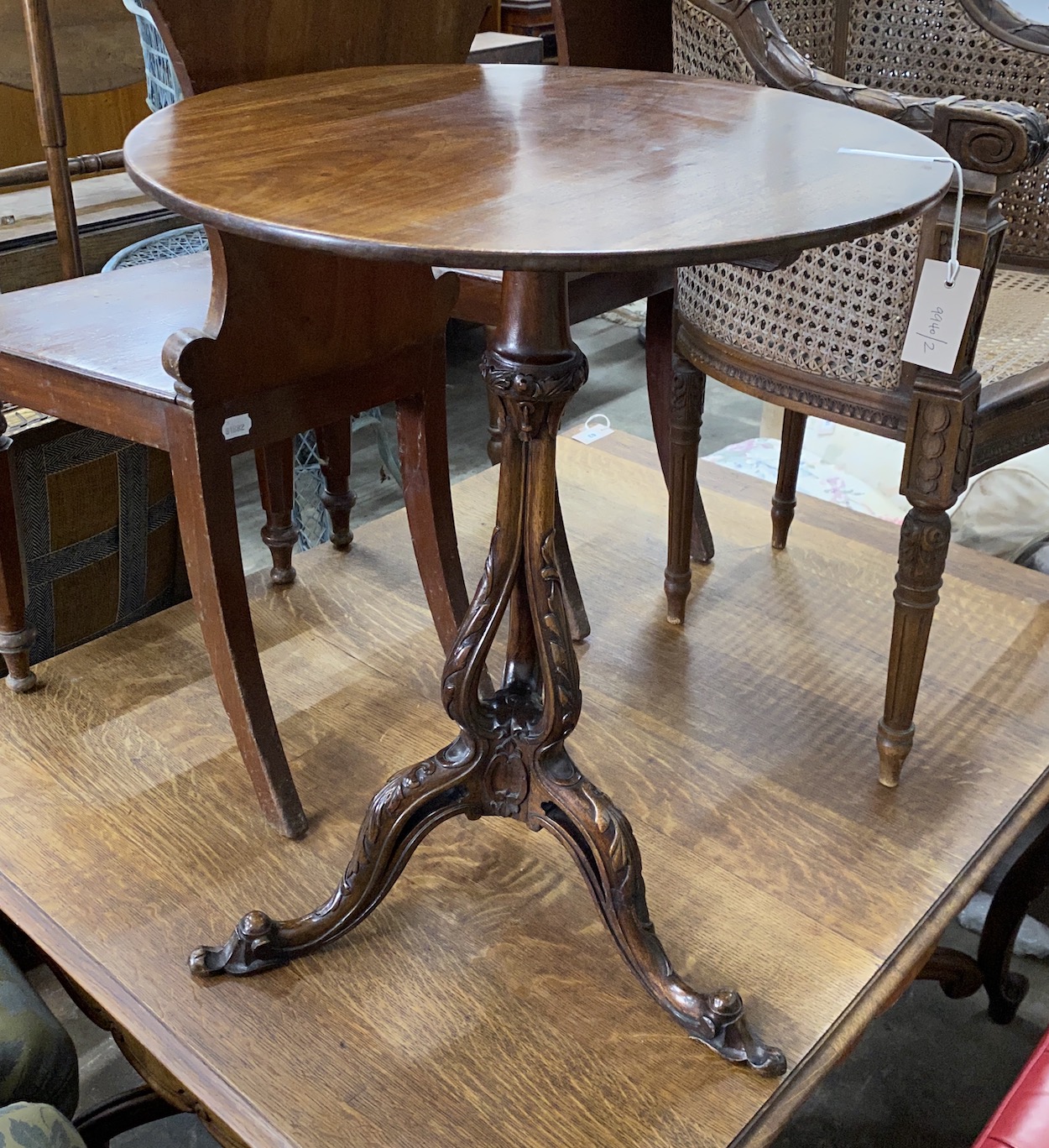 A George III and later mahogany circular tilt top tripod wine table with associated base, diameter 52cm, height 68cm
